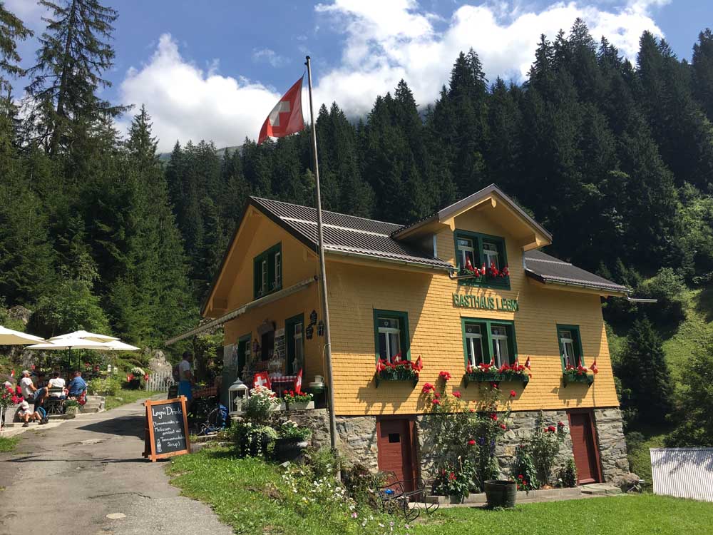 Swiss Gasthaus Legni with flag flying, hiking in switzerland with kids, family friendly alpine trek