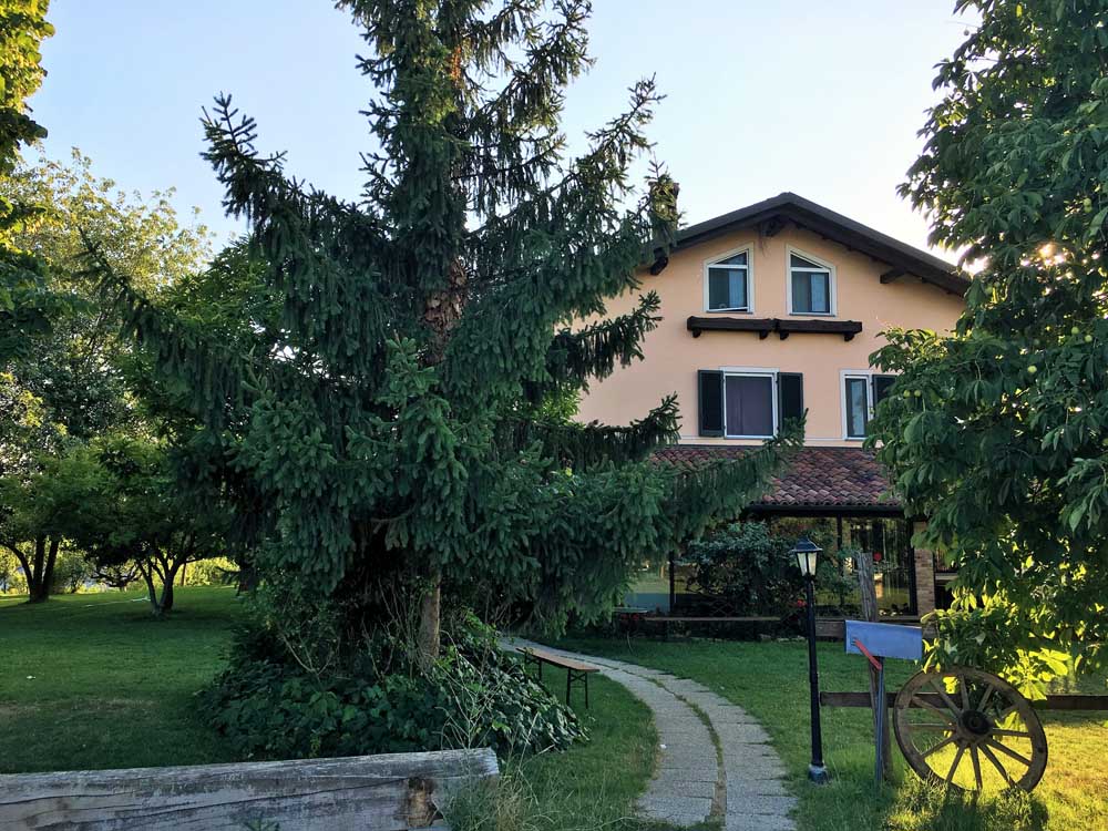 Italy farmhouse surrounded by trees in Piedmont