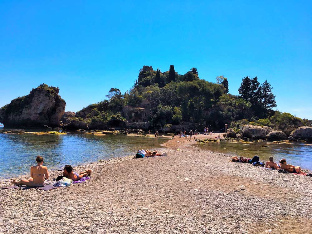 Pebbly beach with island in the background, Isola Bella, Taormina, Sicily