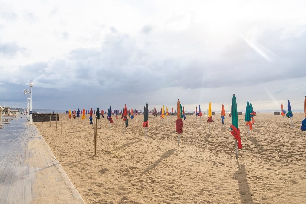 beach near Paris by train, Deauville sandy beach with umbrellas