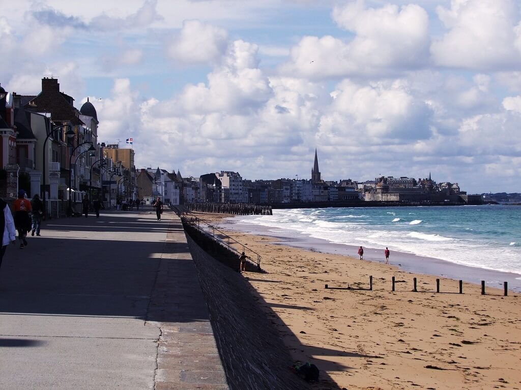 town near paris by train, sandy beach of st malo with town next to it
