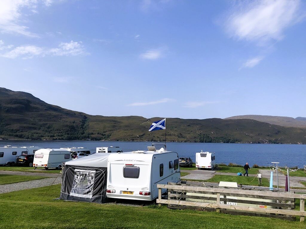 Caravans and motorhomes in Scotland parked next to a Loch